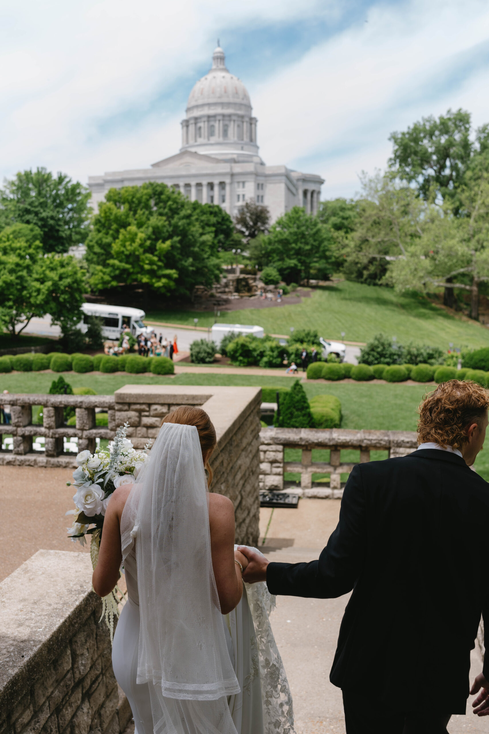 bride and groom entering their ceremony site in jefferson city, missouri